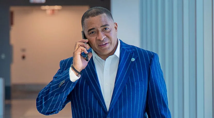 A man in a blue pinstripe suit talking on the phone